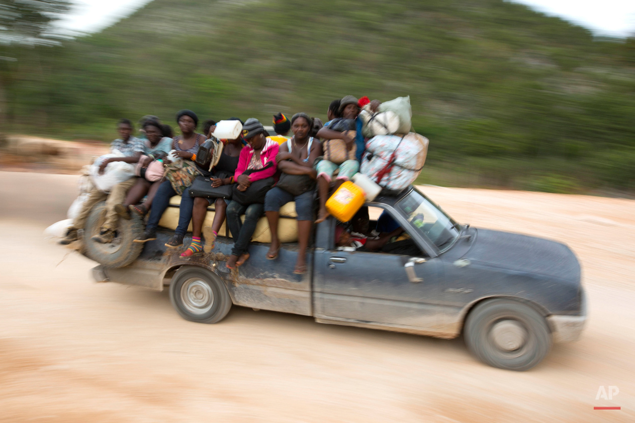  In this July 14, 2015 photo, commuters are transported in a Tap-tap, near the home of Colas Etienne, in Deron, a neighborhood on the outskirts of Pestel, Haiti. Adoptee Mariette Williams flew from South Florida to Haiti, her birth country, to see he