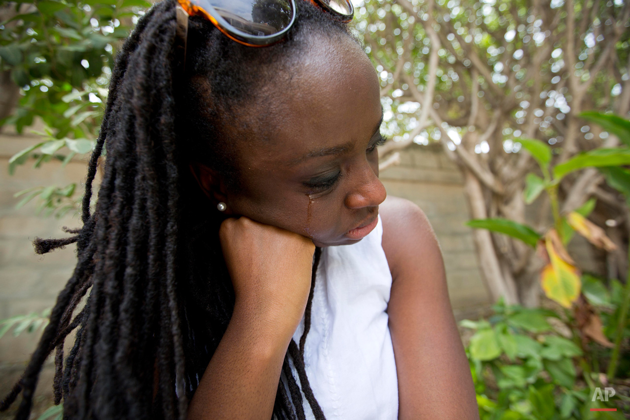  In this July 13, 2015 photo, Mariette Williams cries as she waits to see her birth mother and other family members for the first time in nearly 30 years, in Port-au-Prince, Haiti. She was surprised, and a little annoyed, that her Haitian relatives w