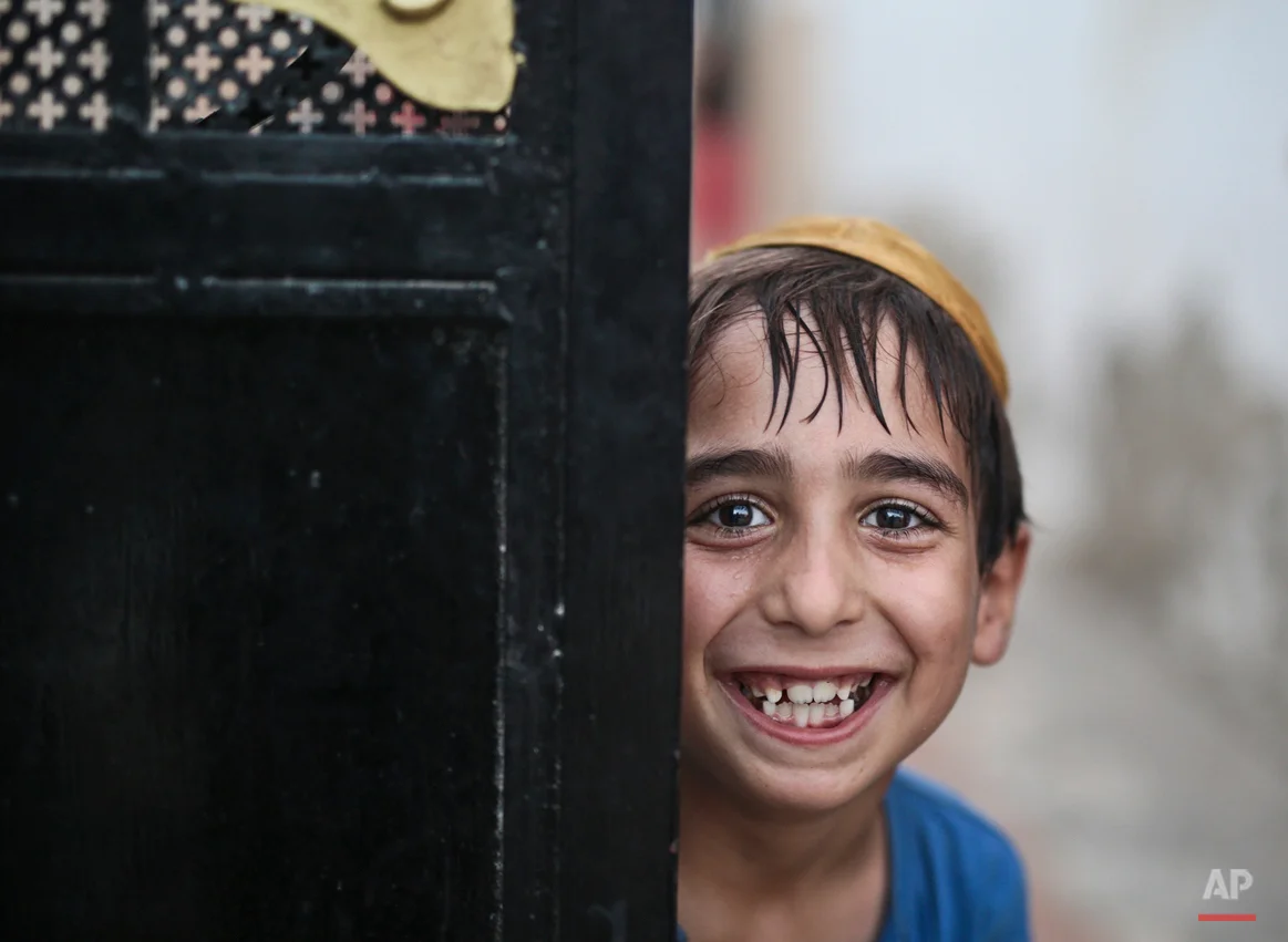  In this Thursday, Oct. 29, 2015 photo, a student covering his head with a Kippah poses for the camera as he leaves the main Talmudic school at Hara Kbira, the main Jewish neighborhood on the Island of Djerba, southern Tunisia. Tunisiaís Jewish popul