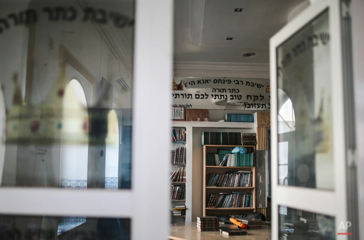 In this Friday, Oct. 30, 2015 photo, Jewish holy books are seen at a library at Hara Kbira, the main Jewish neighborhood on the Island of Djerba, southern Tunisia. The Jewish community in the resort island of Djerba traces its roots all the way back
