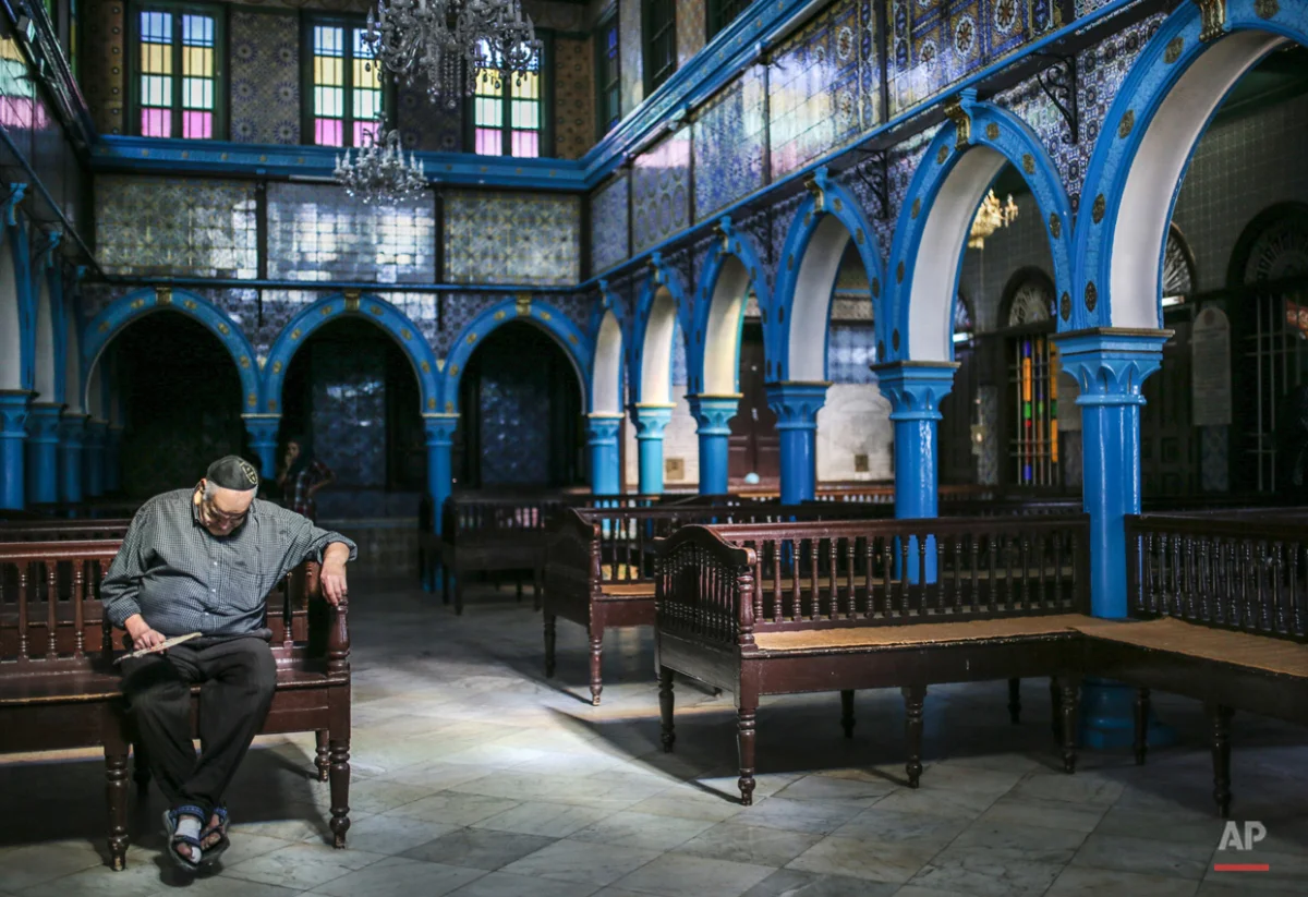  In this Wednesday, Oct. 28, 2015 photo, a Jewish man rests in La Ghriba, the oldest synagogue in Africa, on the Island of Djerba, southern Tunisia. The Jewish community in the resort island of Djerba traces its roots all the way back to Babylonian e