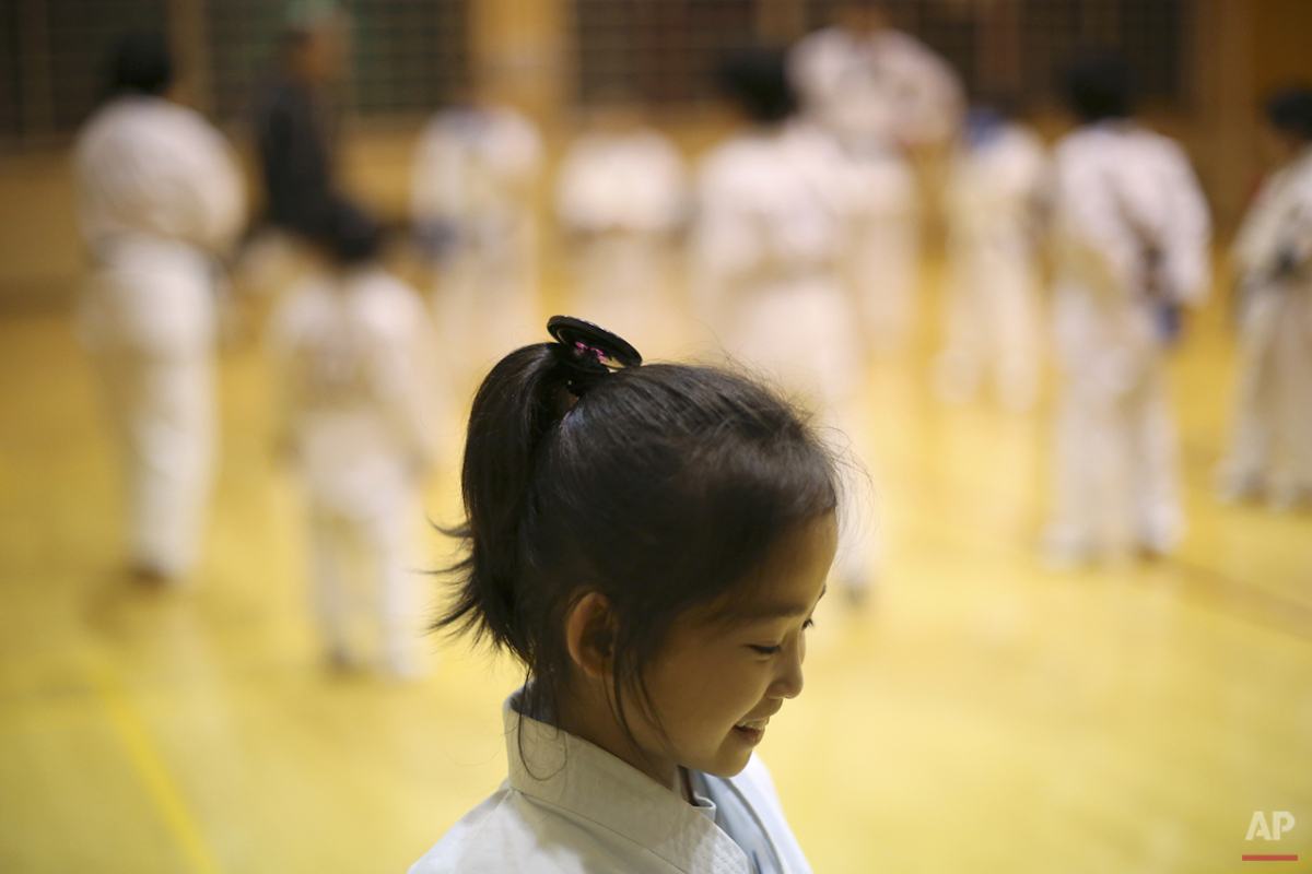  In this Nov. 18, 2015 photo, 9-year-old Mahiro Takano, three-time Japan karate champion in her age group smiles during her karate practice in Nagaoka, Niigata Prefecture, north of Tokyo. Mahiro stars in singer Sia’s latest music video “Alive,” the j