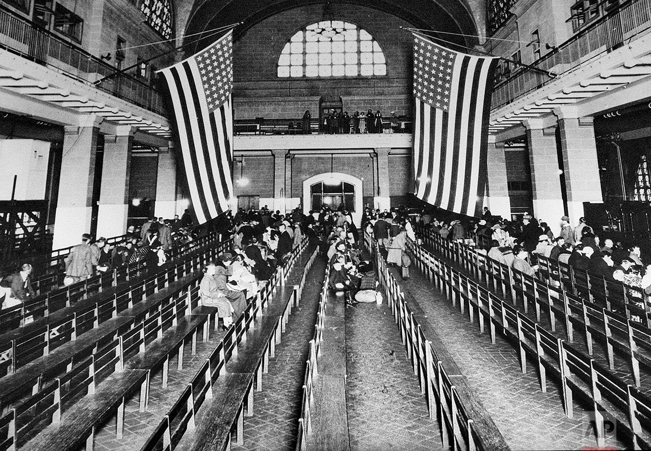 This 1924 photo shows the registry room at Ellis Island in New York harbor, a gateway to America for millions of immigrants. The American self-image is forever intertwined with the melting pot _ a nation that embraces the world’s wretched refuse, a nation built by immigrants. But America’s immigration history is complicated. (AP Photo)