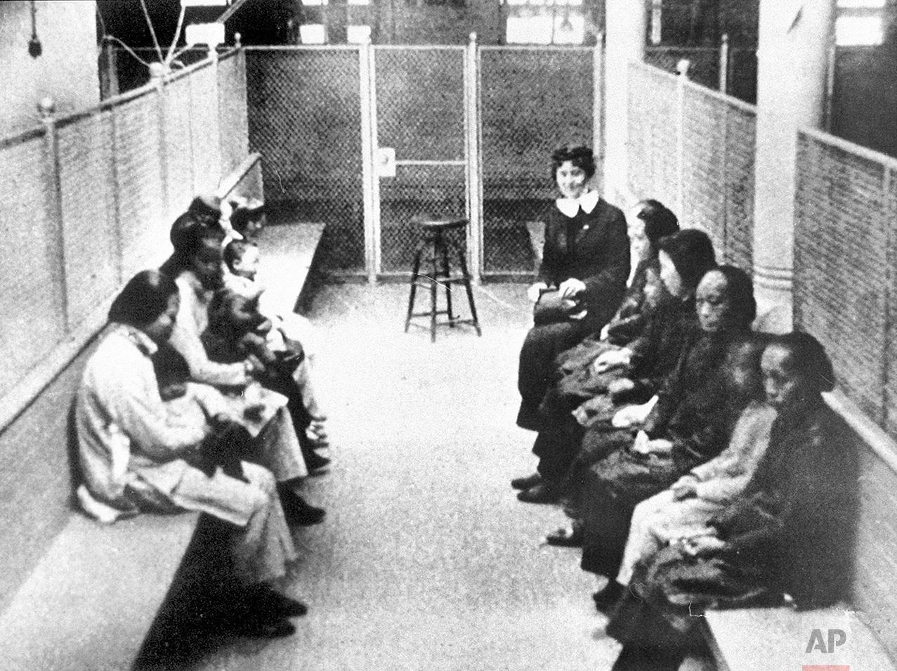  In this late 1920s photo, a group of Chinese and Japanese women and children wait to be processed, held in a wire mesh enclosure at the Angel Island Internment barracks in San Francisco Bay. The Angel Island Immigration Station processed one million immigrants from 1910 to 1940, mostly from China and Japan. (AP Photo)