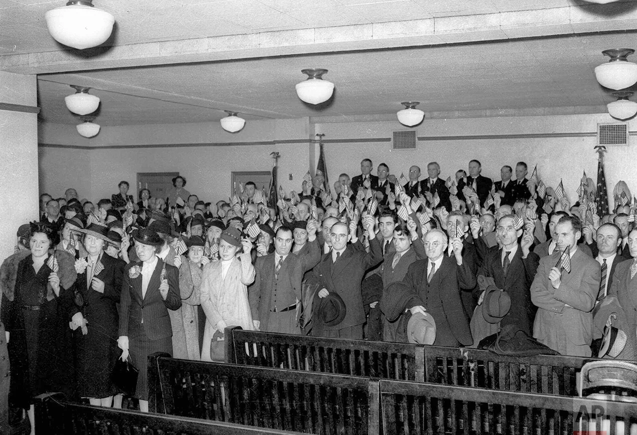 In this April 12, 1939 photo, 126 new citizens of the United States are sworn in at the U.S. District Court in Philadelphia. The United States is far less inviting than it once was: The number of immigrants obtaining legal permanent resident status in 2010 was just over a million _ almost precisely the same number as it was a hundred years earlier, when the population was less than a third of what it is in 2017. (AP Photo)