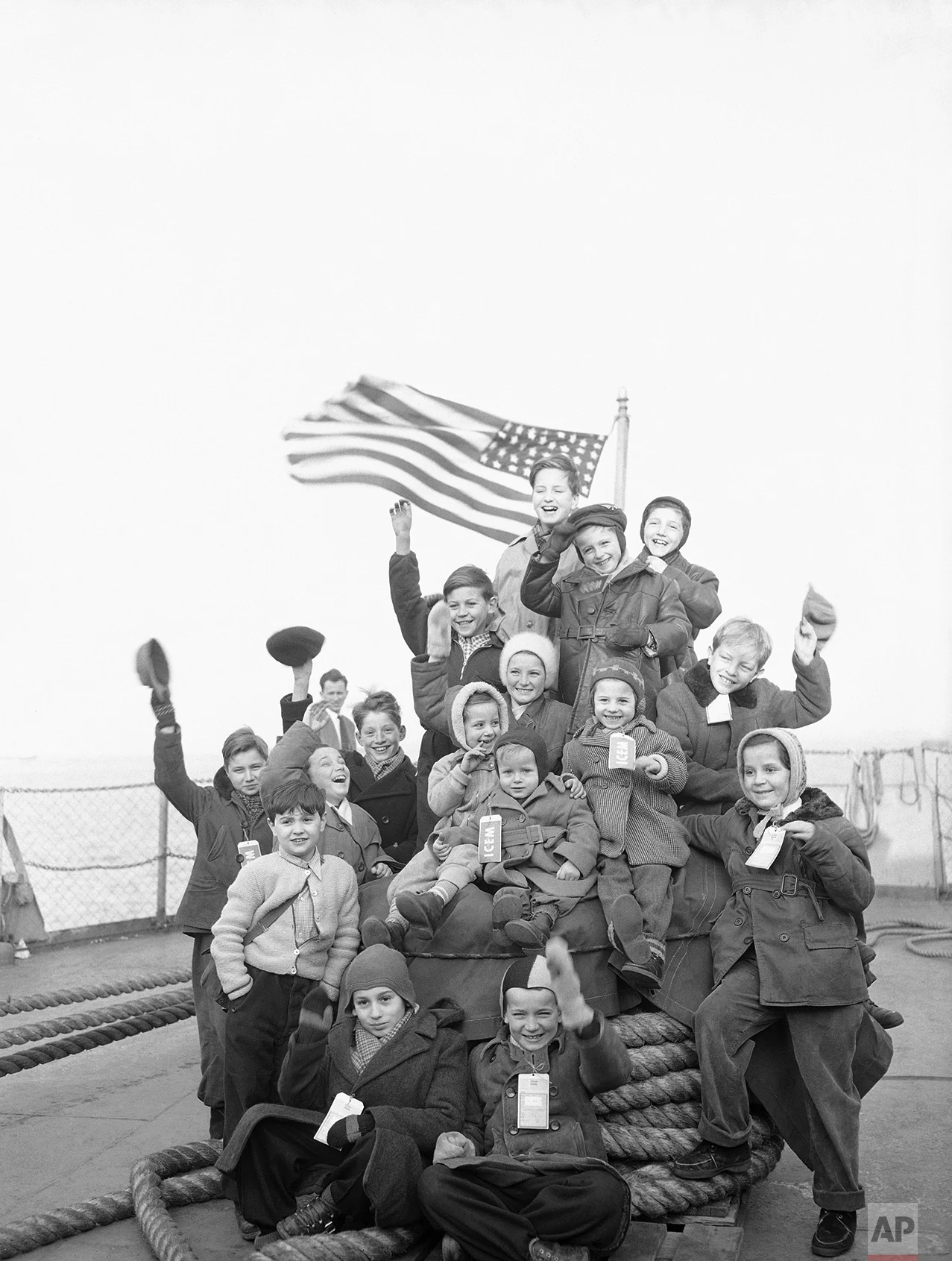 A happy group of Hungarian youngsters needs no prompting to smile for the photographer for this pose aboard the Navy transport Gen. Walker which brought nearly 2,000 Hungarians to New York Feb.15, 1957. They were a part of the largest group of refugees to arrive in the United States through the Government's sea-lift. After docking, they were transported to Camp Kilmer, N.J., for processing. (AP Photo/Anthohny Camerano)