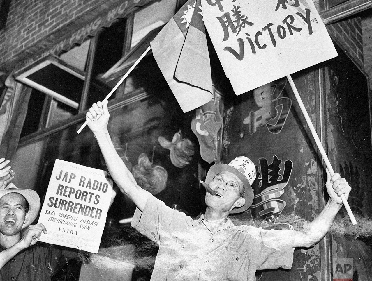 In this Aug. 14, 1945 photo, Chinese-Americans on Mott and Pell Streets in New York's Chinatown celebrate the Japanese surrender on V-J Day. In 1868, the U.S. signed a treaty encouraging Chinese migration; 24 years later, the Chinese Exclusion Act turned away immigrants from what was even then the world’s most populous nation. (AP Photo/Tom Fitzsimmons)