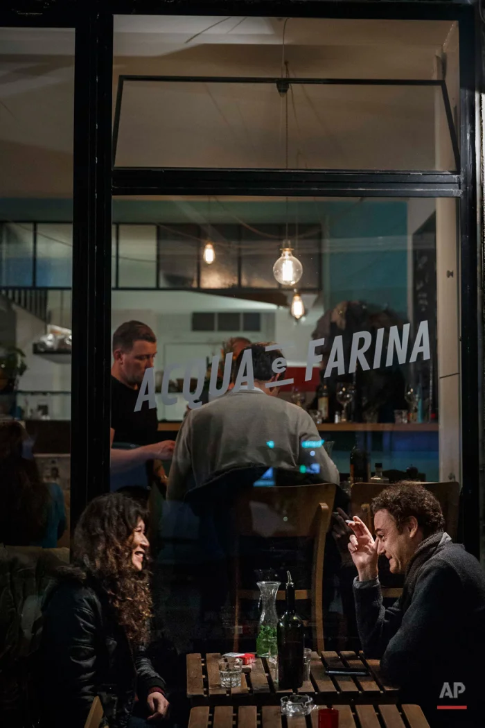  In this Nov. 17, 2015 picture people enjoy at 'Acqua e Farina', close to one of the spots of Friday's attacks in Paris. Parisians are returning to cafes, bars and restaurants, determined that the Nov. 13 attacks won't alter the city's way of life. P