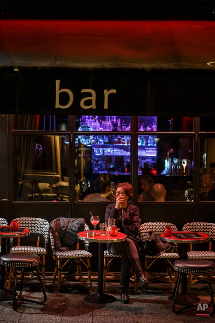  In this Nov. 17, 2015 picture people enjoy dinner at 'Iguana Cafe' close to one of the spots of Friday's attacks in Paris. Parisians are returning to cafes, bars and restaurants, determined that the Nov. 13 attacks won't alter the city's way of life