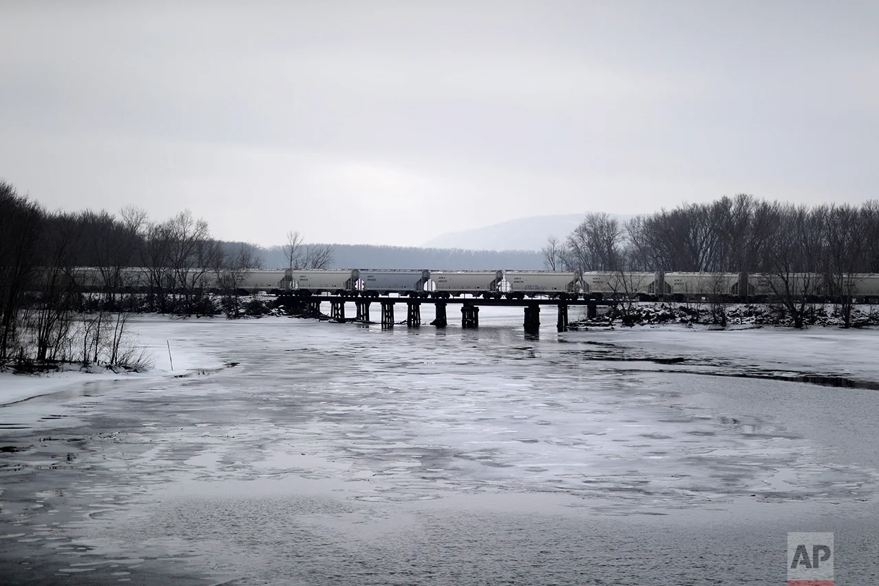 A train travels over the Mississippi River in Prairie du Chien, Wis., Wednesday, Jan. 18, 2017. So many voters switched from blue to red in some 50 counties stretching 300 miles down the Mississippi River, through Minnesota, Wisconsin, Iowa and Illinois, that it transformed in one election season into Donald Trump Country. (AP Photo/David Goldman)