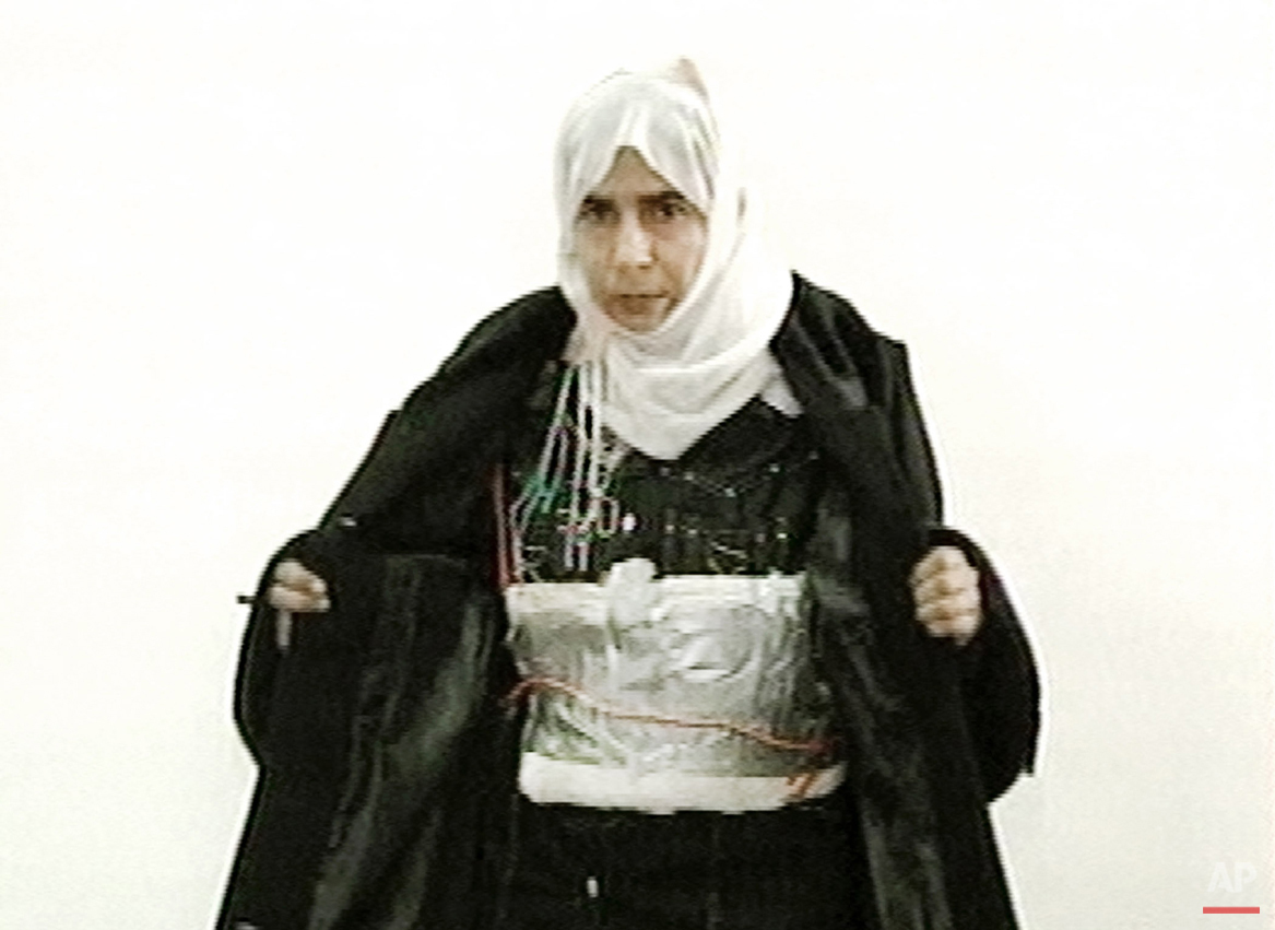  This image made from television on Sunday Nov. 13, 2005 shows Iraqi Sajida Mubarek Atrous al-Rishawi opening her jacket and showing an explosive belt as she confesses on Jordanian state-run television to her failed bid to set off an explosives belt 