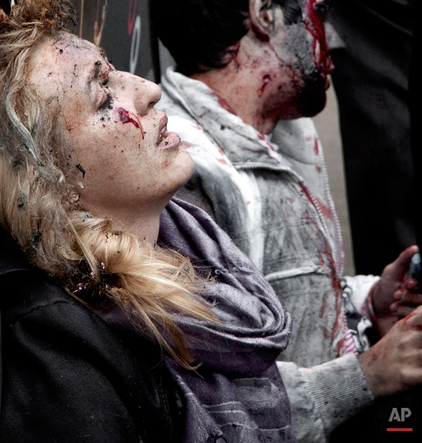  In this Monday, March 29, 2010 photo, commuters injured by a bomb blast at the Park Kultury subway station in Moscow wait for medical care just outside the station shortly after female suicide bombers blew themselves in twin attacks on Moscow subway