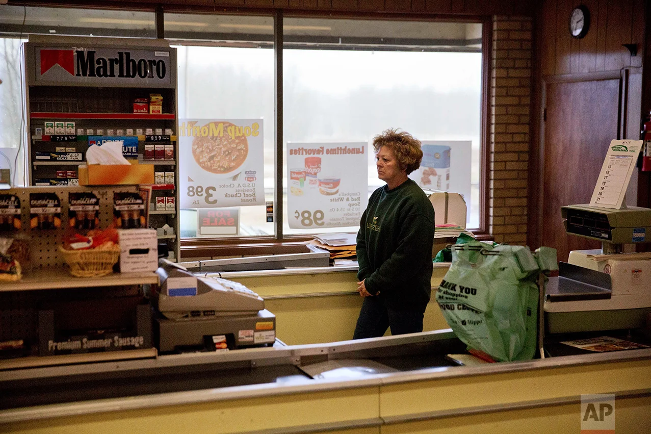 Mary Stuckey, who owns the only market in town with her husband, waits for customers in Wauzeka, Wis., Friday, Jan. 20, 2017. The mom-and-pop grocery store has been a fixture in the community for more than 100 years. But the owners - who hope to retire and have had the store on the real estate market for a few years with no takers - say business has slowed, partly because residents are willing to travel longer distances to shop at grocery and big box stores in Prairie du Chien. (AP Photo/David Goldman)