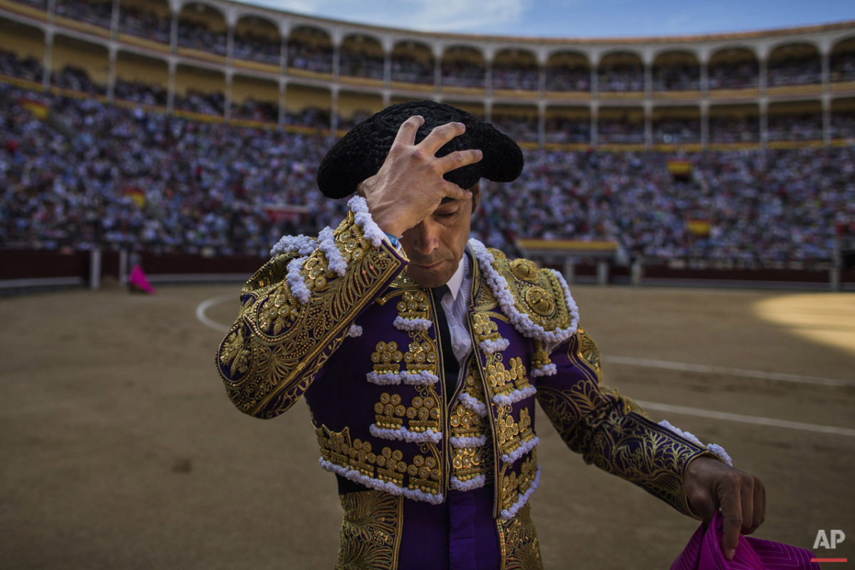  Bullfighter Manuel Jesus 'El Cid' gestures adjusts his montera hat as he gets ready to perform with a Victorino Martin ranch fighting bull during a bullfight at Las Ventas bullring in Madrid, Spain, Friday, June 5, 2015. Bullfighting is a traditiona