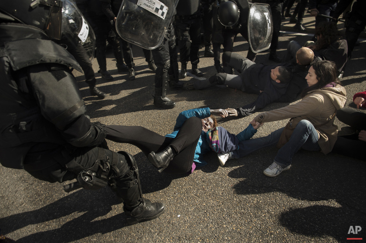  Riot Police remove housing rights activists as they tries to stop Luisa Gracia Gonzalez and her family's eviction and the demolition of their house by a forced expropriation in Madrid, Spain, Friday, Feb. 27, 2015. Madrid authorities say 11 people w