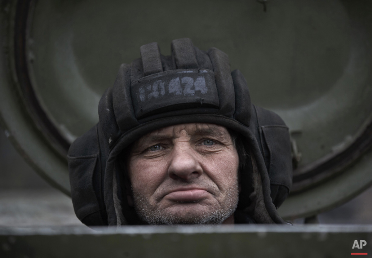  A Russia-backed separatist fighter sits in a self propelled 152 mm artillery piece, part of a unit moved away from the front lines, in Yelenovka, near Donetsk, Ukraine,Thursday, Feb. 26, 2015. (AP Photo/Vadim Ghirda) 