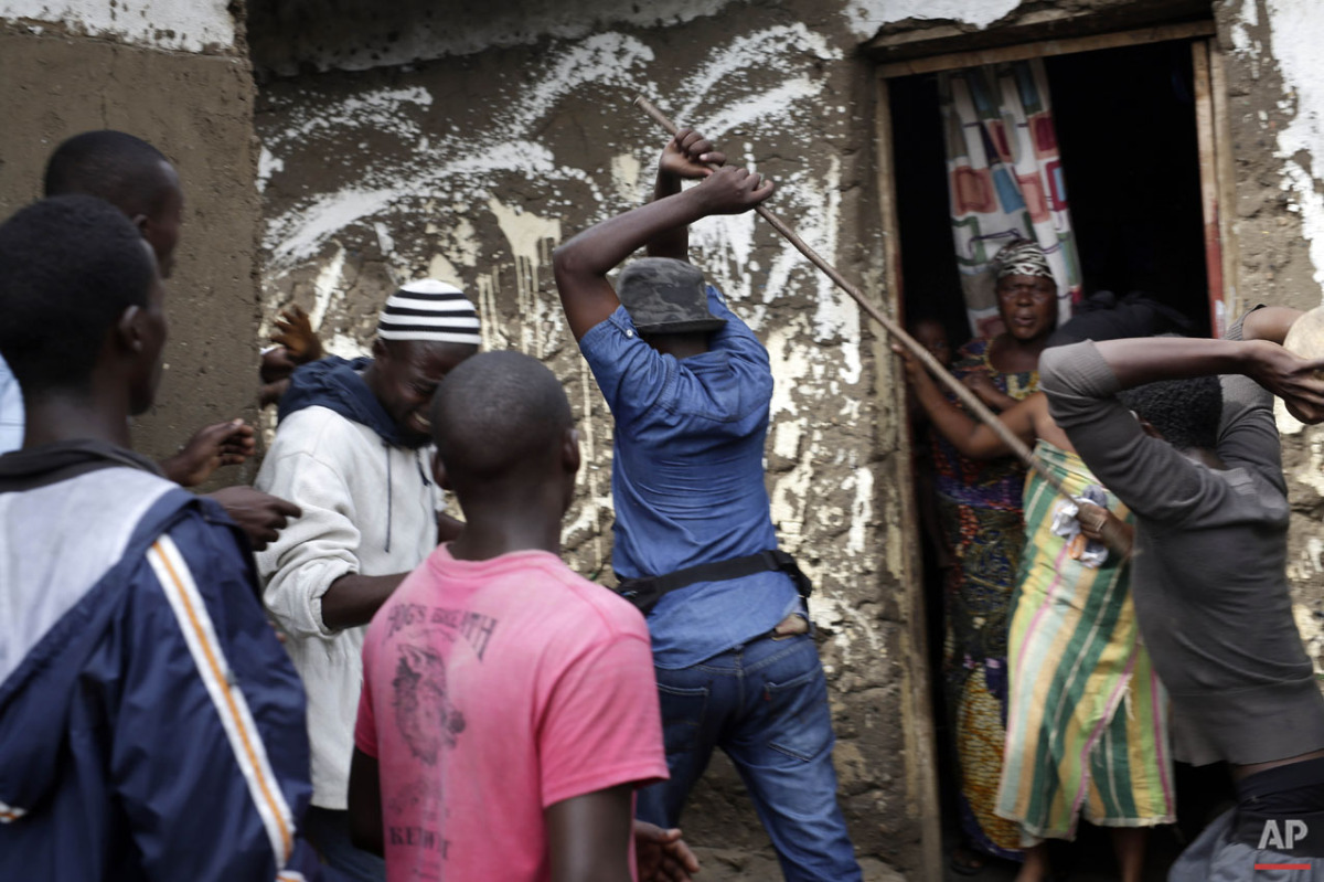  Demonstrators corner a suspected member of the ruling party's Imbonerakure youth militia at his home in the Cibitoke district of Bujumbura, Burundi, Thursday May 7, 2015. (AP Photo/Jerome Delay) 