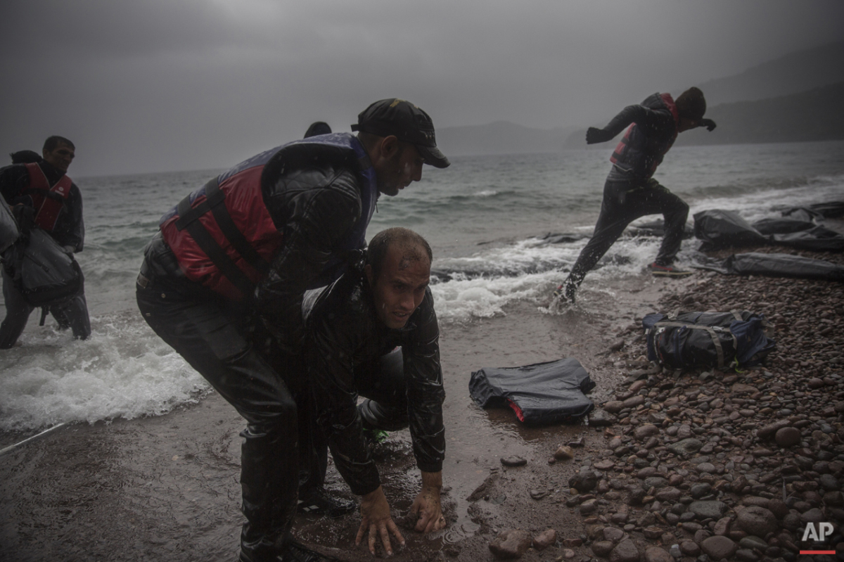  Migrants disembark from a dinghy on a beach after arriving from the Turkish coast to the village of Skala Sikaminias on the northeastern Greek island of Lesbos, on Thursday, Oct. 22, 2015. (AP Photo/Santi Palacios) 