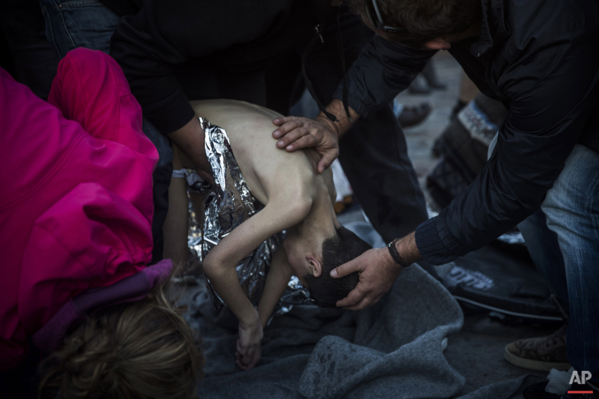  Paramedics and doctors try to revive a young boy after a boat with refugees and migrants sank while crossing the Aegean sea from Turkey to the Greek island of Lesbos, on Wednesday, Oct. 28, 2015. The condition of the child is not known. (AP Photo/Sa