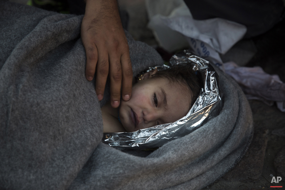  Paramedics and doctors care for a baby girl after a boat with refugees and migrants sunk while was crossing the Aegean sea from Turkey to the Greek island of Lesbos on Wednesday, Oct. 28, 2015. The condition of the child is not known. (AP Photo/Sant