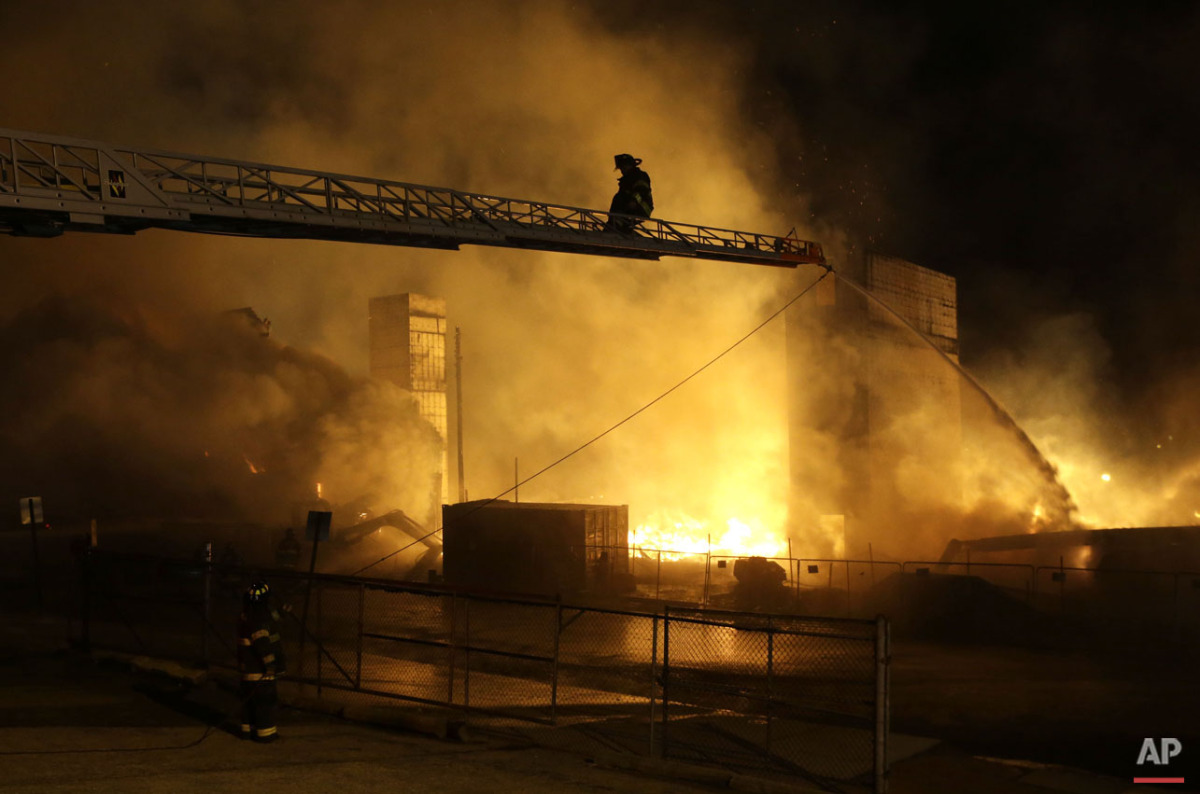  Firefighters fight a fire in eastern Baltimore, Monday, April 27, 2015, during unrest following the funeral of Freddie Gray in Baltimore. (AP Photo/Patrick Semansky) 