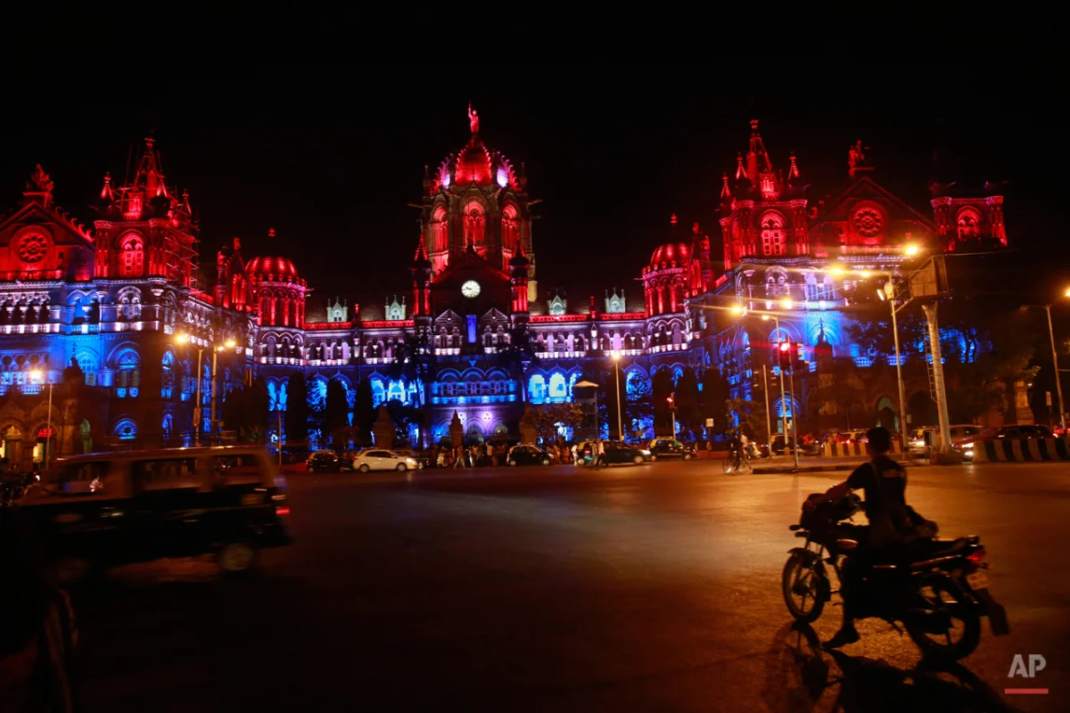 Mumbaiís Chhatrapati Shivaji train station building is illuminated by the colors of the French national flag in solidarity with France following Fridayís Paris terror attacks, Mumbai, India, Sunday, Nov. 15, 2015. This Mumbai landmark was one of the major targets of the 2008 terror attacks that killed 166 people. (AP Photo/Rafiq Maqbool)