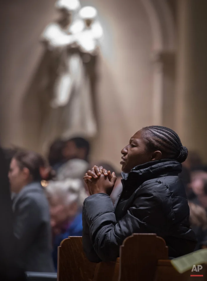 The faithful attend Mass offered in French at the Church of Notre Dame Sunday, Nov. 15, 2015, in New York where special prayers were said for victims of the terror attacks in Paris. Friday's attacks on a stadium, a concert hall and Paris cafes left at least 129 people dead and over 350 wounded. In Paris the streets were enveloped in mourning, flags were lowered and Notre Dame Cathedral ñ like many sites in Paris ñ was closed to tourists but a special church service was scheduled on Sunday for families of the victims. (AP Photo/Bryan R. Smith)