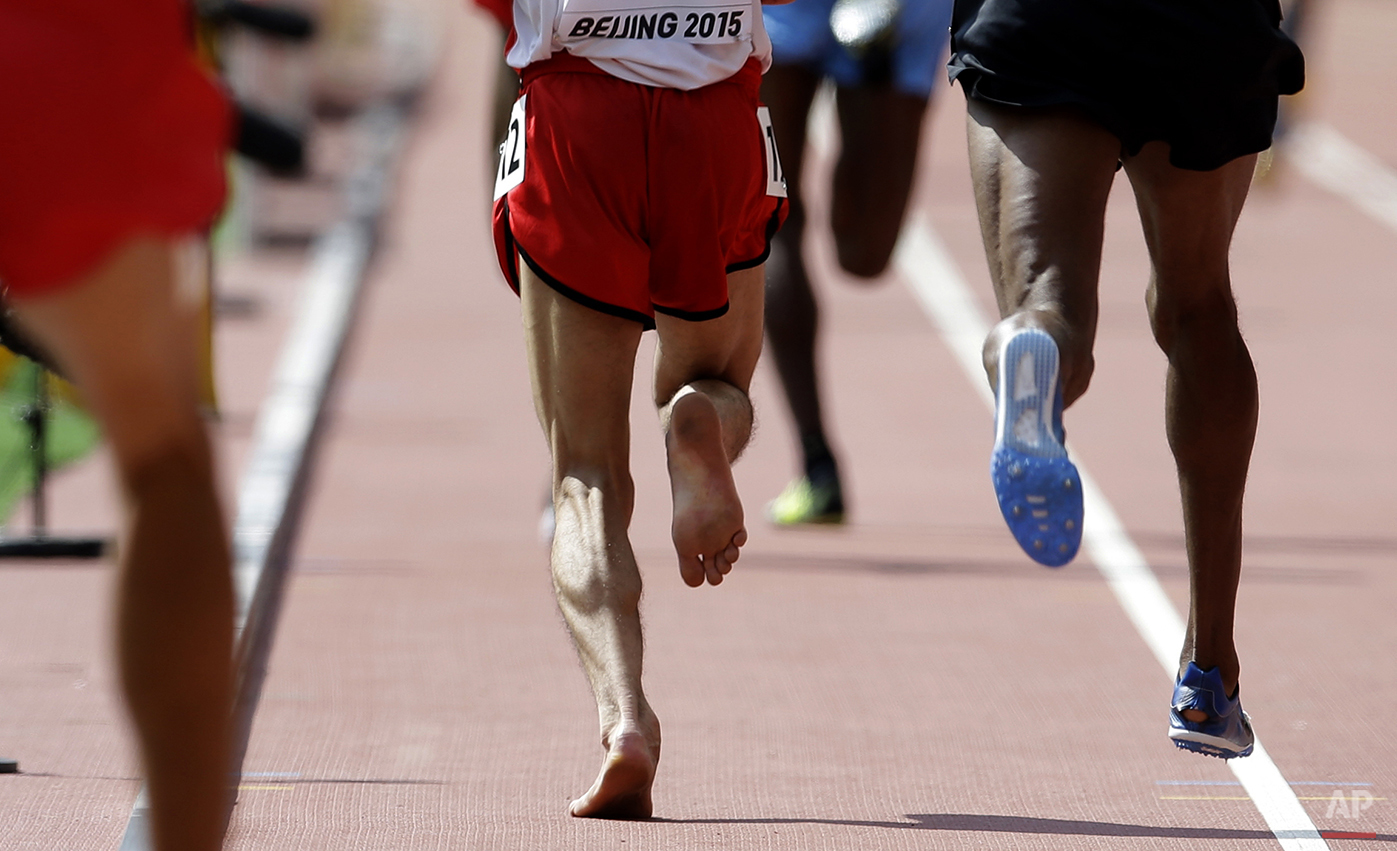  Yemen's Abdullah Al-Qwabani competes barefoot in a men’s 5000m round one heat at the World Athletics Championships at the Bird's Nest stadium in Beijing, Wednesday, Aug. 26, 2015. (AP Photo/Kin Cheung) 