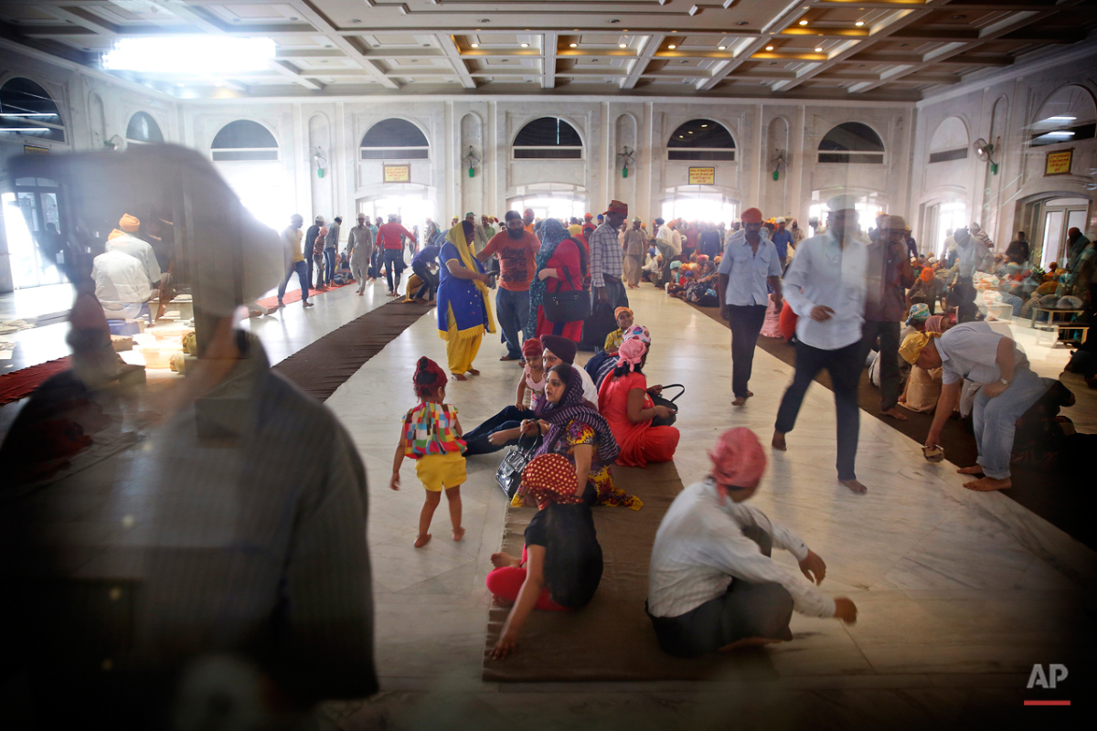  In this May 12, 2015 photo, devotees arrive to have langar at the Bangla Sahib Gurudwara or Sikh temple, in New Delhi, India. The langar, which translates to community meal, begins at noon in a large, high-ceilinged hall at the Bangla Sahib Gurudwar