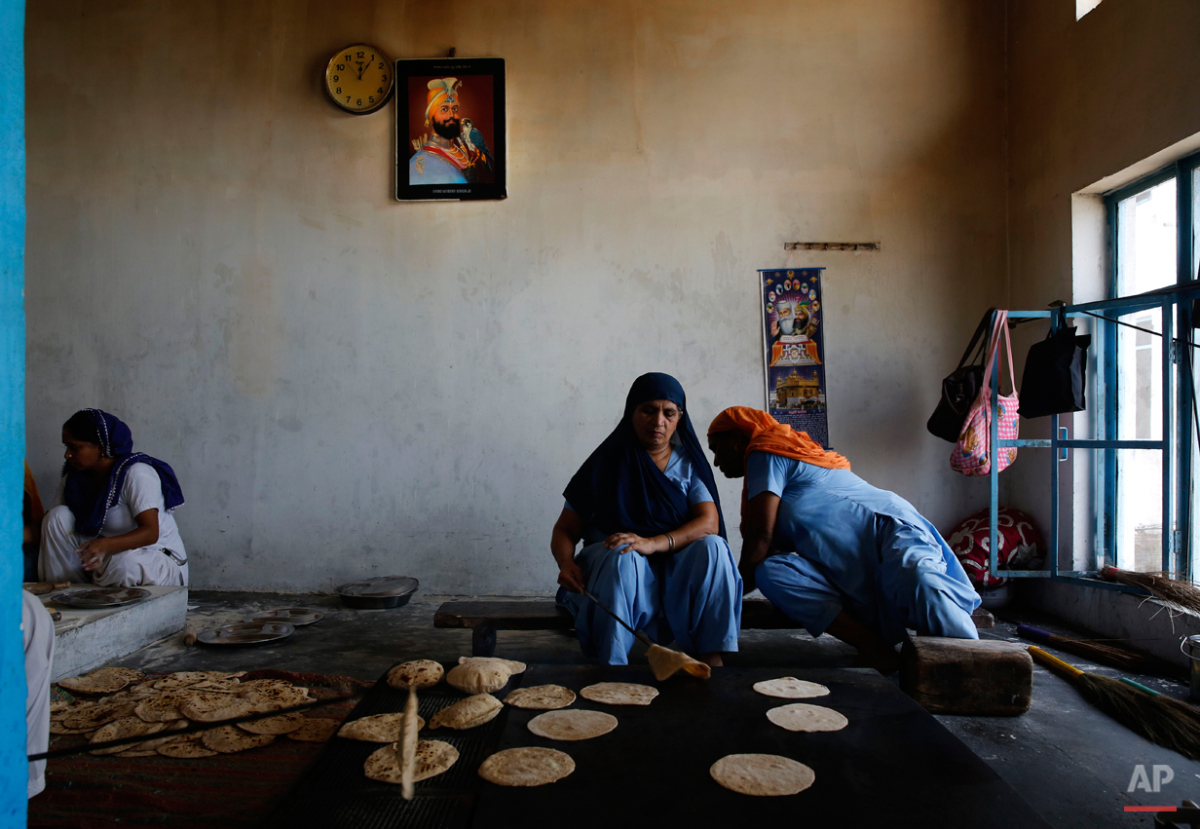  In this June 4, 2015 photo, women prepare Indian breads for langar, which translates to community dinner, for devotees Majnu-ka-Tilla Gurudwara or Sikh temple, in New Delhi, India. Service is one of the most integral traditions of gurudwaras. From c