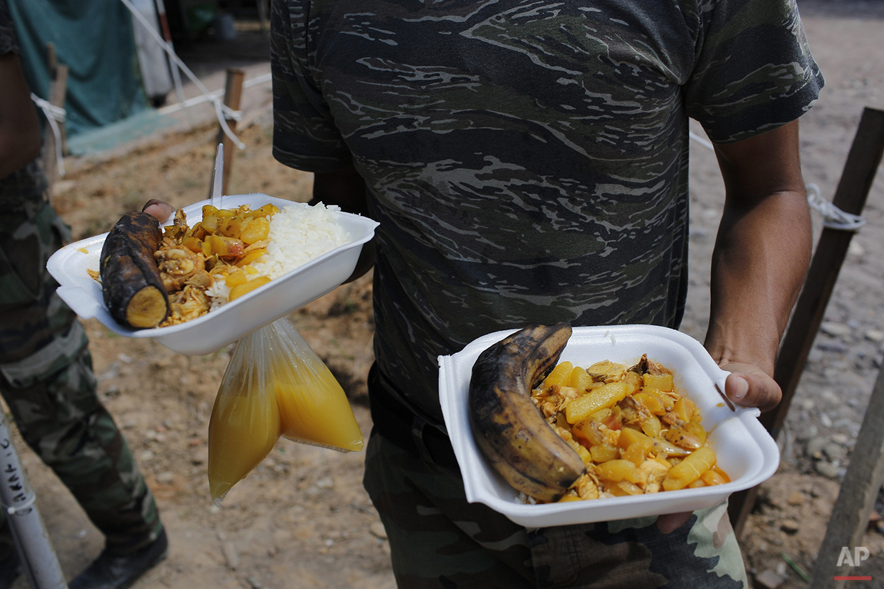  In this July 29, 2015 photo, a counternarcotics special forces officer carries his lunch at mess hall in the police the base in Ciudad Constitucion, Peru. The Tactical Anti-Drug Operations Group to which he belongs numbers 90 officers. (AP Photo/Rod