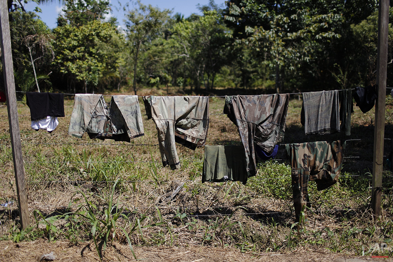  In this July 29, 2015 photo, counternarcotics special forces dry their clothes on a barbed wire fence inside their base in Ciudad Constitucion, Peru. The Tactical Anti-Drug Operations Group includes paramedics, sharpshooters and scuba divers. (AP Ph