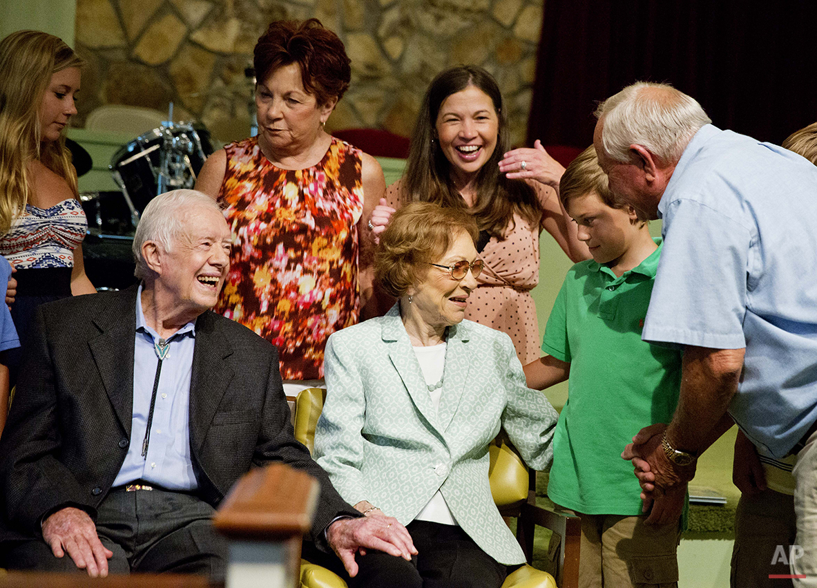  Former President Jimmy Carter, left, sits with his wife Rosalynn as they pose for photos with Bill Bush, of Adel, Ga., from right, his grandson Carson Shirley, 9, daughter Lara Norris, and wife Pat Bush after Carter taught Sunday School class at Mar