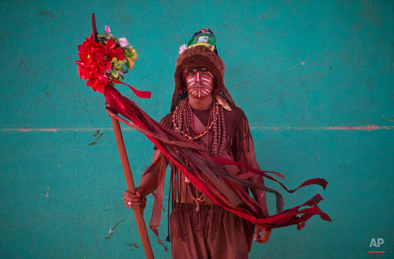  In this Aug. 4, 2015 photo, Jose Martin Tallen, 46, poses for a portrait dressed as an Indian during Managua's patron saint, Santo Domingo de Guzman's celebration, in Managua, Nicaragua. Tallen who is originally from the country's Caribbean coast sa