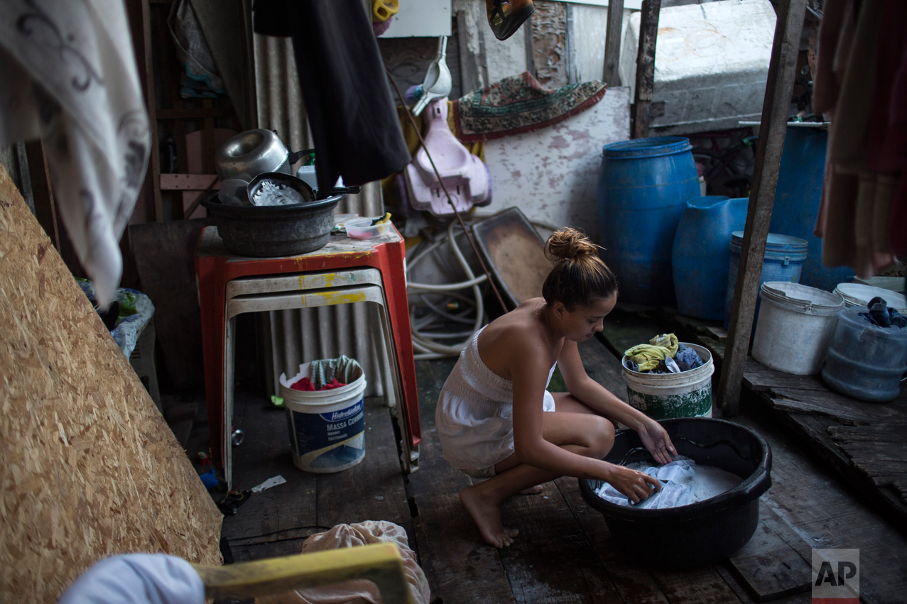  Marilia da Silva, 14, washes clothes near water storage containers, potential mosquito breeding sites, outside her house in a slum of Recife, Brazil, Friday, Feb. 5, 2016. The Zika virus, spread by the Aedes aegypti mosquito, thrives in people's hom