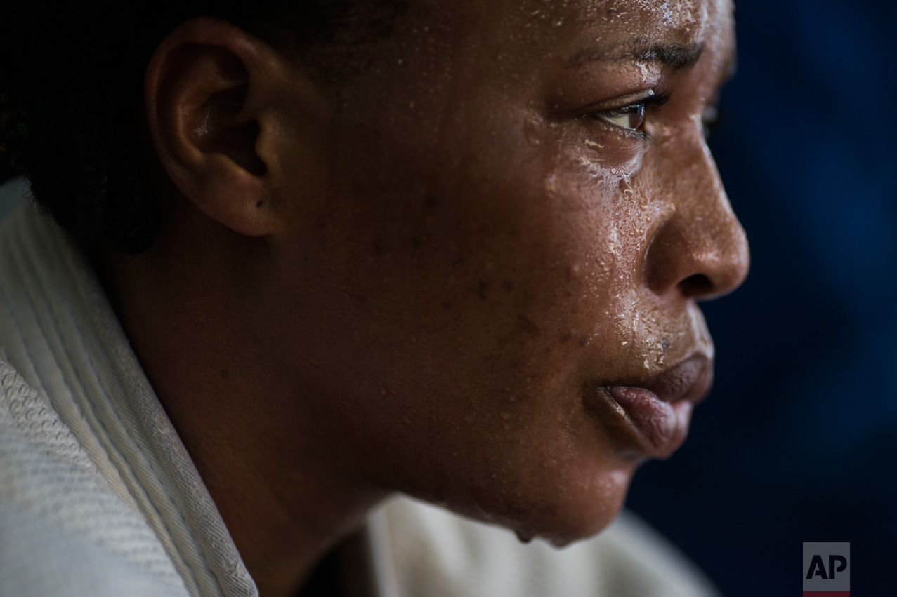  In this May 26, 2016 photo, Yolande Mabika, a refugee from the Democratic Republic of Congo, takes a break during Judo training at the Reacao Institute in Rio de Janeiro, Brazil, as she trains in hopes of making the cut for the first Olympic team of