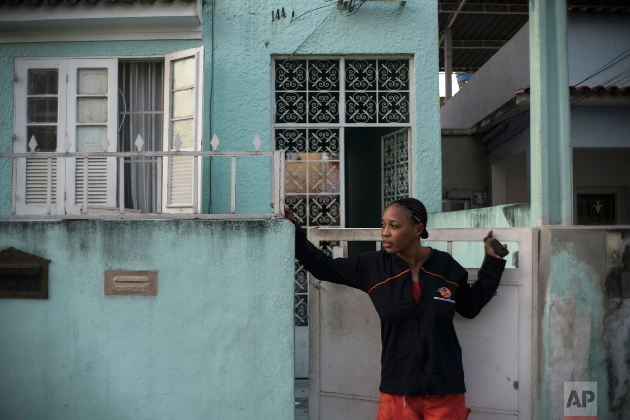  In this May 28, 2016 photo, Yolande Mabika, a refugee and judo athlete from the Democratic Republic of Congo who hopes to join the first Olympic team of refugee athletes, stands at the entrance of her newly rented apartment in Rio de Janeiro, Brazil