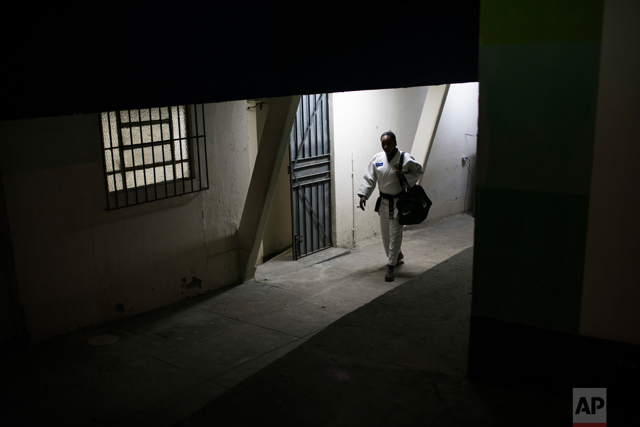  In this May 27, 2016 photo, Yolande Mabika, a refugee from the Democratic Republic of Congo, walks to judo training at the Reacao Institute in Rio de Janeiro, Brazil, in hopes of making the cut for the first Olympic refugee team. Getting to the poin