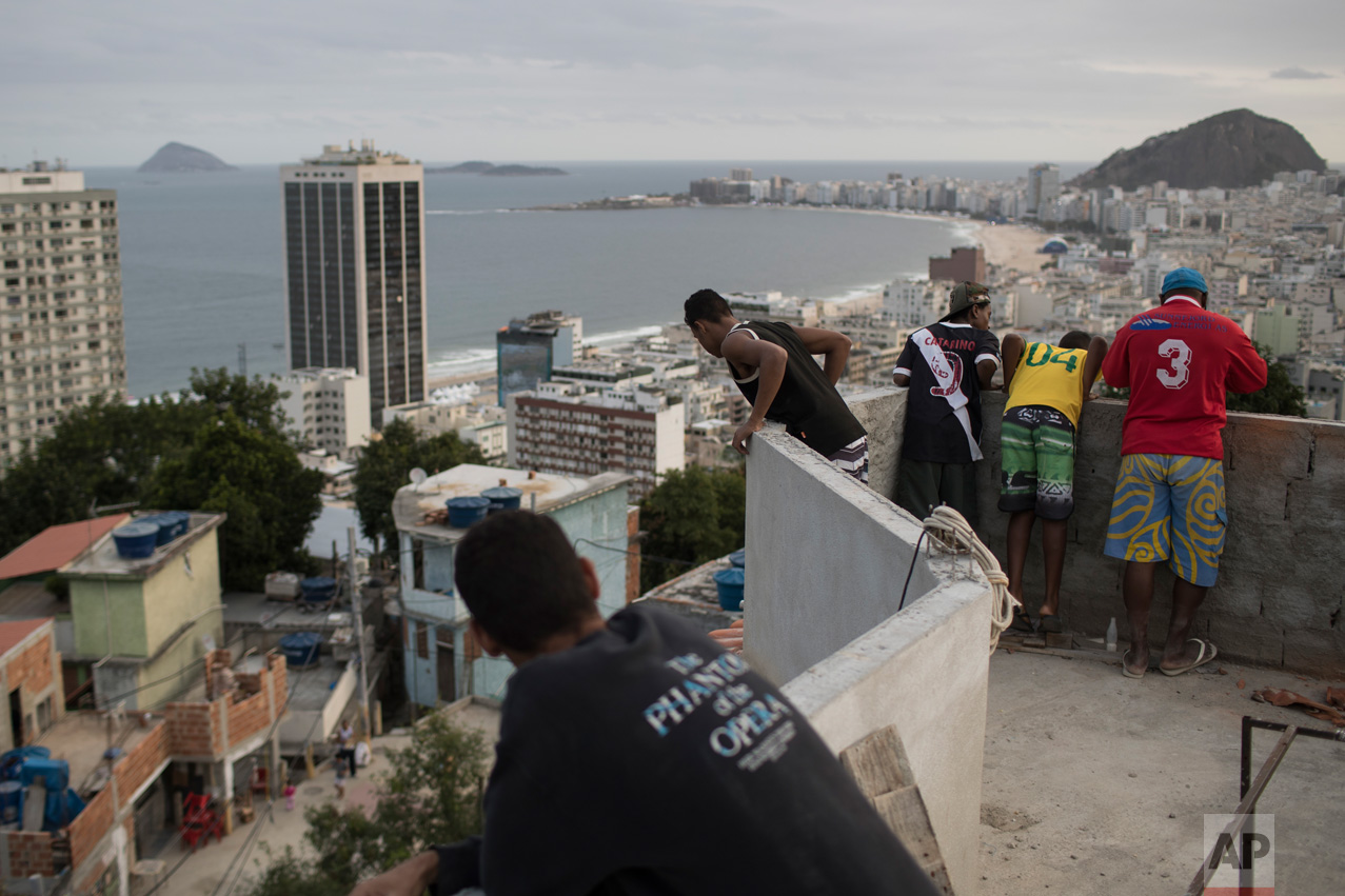  Boys look at kites atop the Babilonia slum, overlooking Copacabana beach in Rio de Janeiro, Brazil, Wednesday, Aug. 3, 2016. (AP Photo/Felipe Dana) 