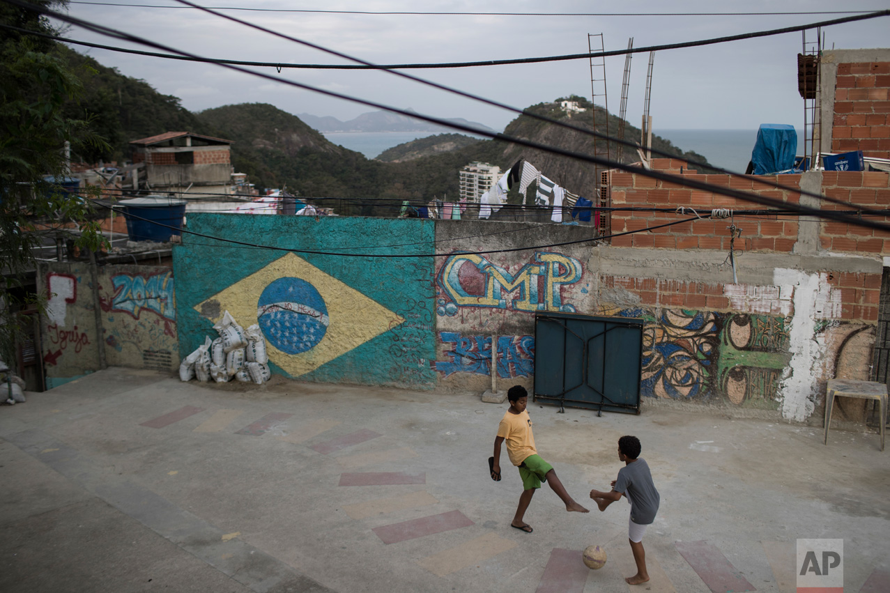  Boys play soccer at the Babilonia slum, overlooking Copacabana beach in Rio de Janeiro, Brazil, Wednesday, Aug. 3, 2016.  (AP Photo/Felipe Dana) 