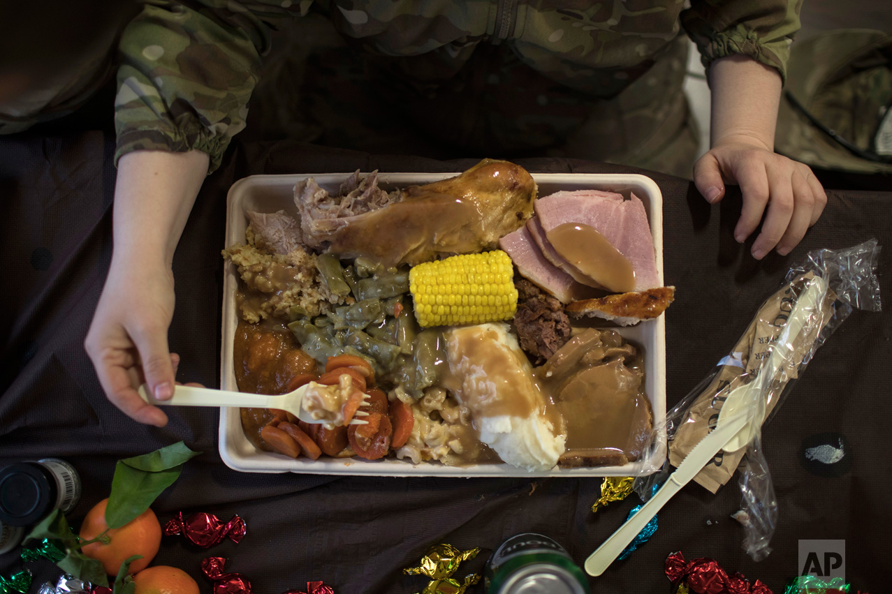  An U.S. Army soldier eats Thanksgiving dinner at a coalition air base in Qayara south of Mosul, Iraq, Thursday, Nov. 24, 2016. (AP Photo/Felipe Dana) 
