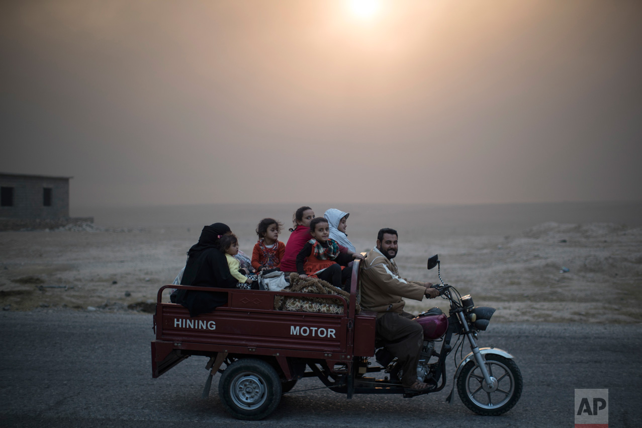  A displaced Iraqi family rides back to their home at the outskirts of Qayara, south of Mosul, Iraq, Thursday, Nov. 3, 2016. A senior military commander says more than 5,000 civilians have been evacuated from newly-retaken eastern parts of the Islami