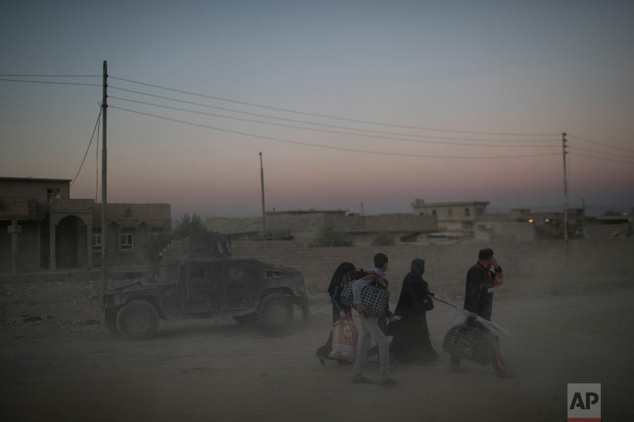  Iraqis flee fighting between Iraqi forces and Islamic State militants on a road in eastern Mosul, Iraq, Friday, Nov. 25, 2016. (AP Photo/Felipe Dana) 