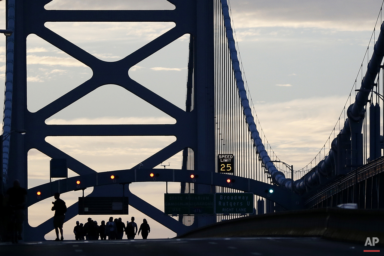  A family from Trenton, N.J., originally from Ecuador, walk over the Benjamin Franklin Bridge ahead of a Sunday Mass to be delivered by Pope Francis, Sunday, Sept. 27, 2015, in Philadelphia. Pope Francis celebrated a climactic outdoor Mass on the Ben
