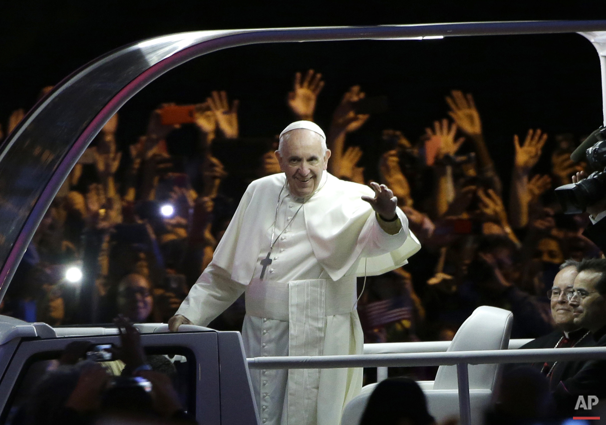  Pope Francis waves as he rides in the pope mobile in the Papal Parade during the Festival of Families, Saturday, Sept. 26, 2015, in Philadelphia. (AP Photo/Matt Rourke, Pool) 