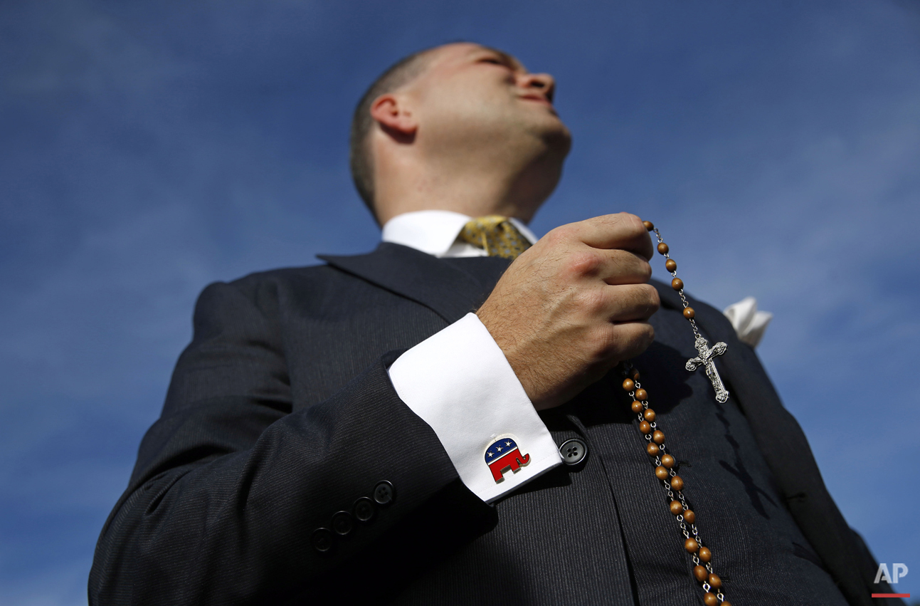  Paul Marich of Woodbridge, Va., prays the rosary as he waits outside the Capitol in Washington, Thursday, Sept. 24, 2015, for a chance to see the Pope Francis after his address to a joint session of Congress. (AP Photo/Patrick Semansky) 