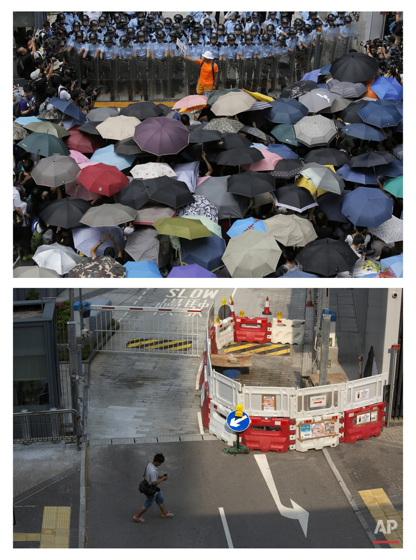  This combination of Sept. 27, 2014 file, top, and Sept. 26, 2015, photos shows a protester holding a placard that reads: "Occupy Central" between anti-riot policemen and protesters outside the government headquarters during the Umbrella Movement in 