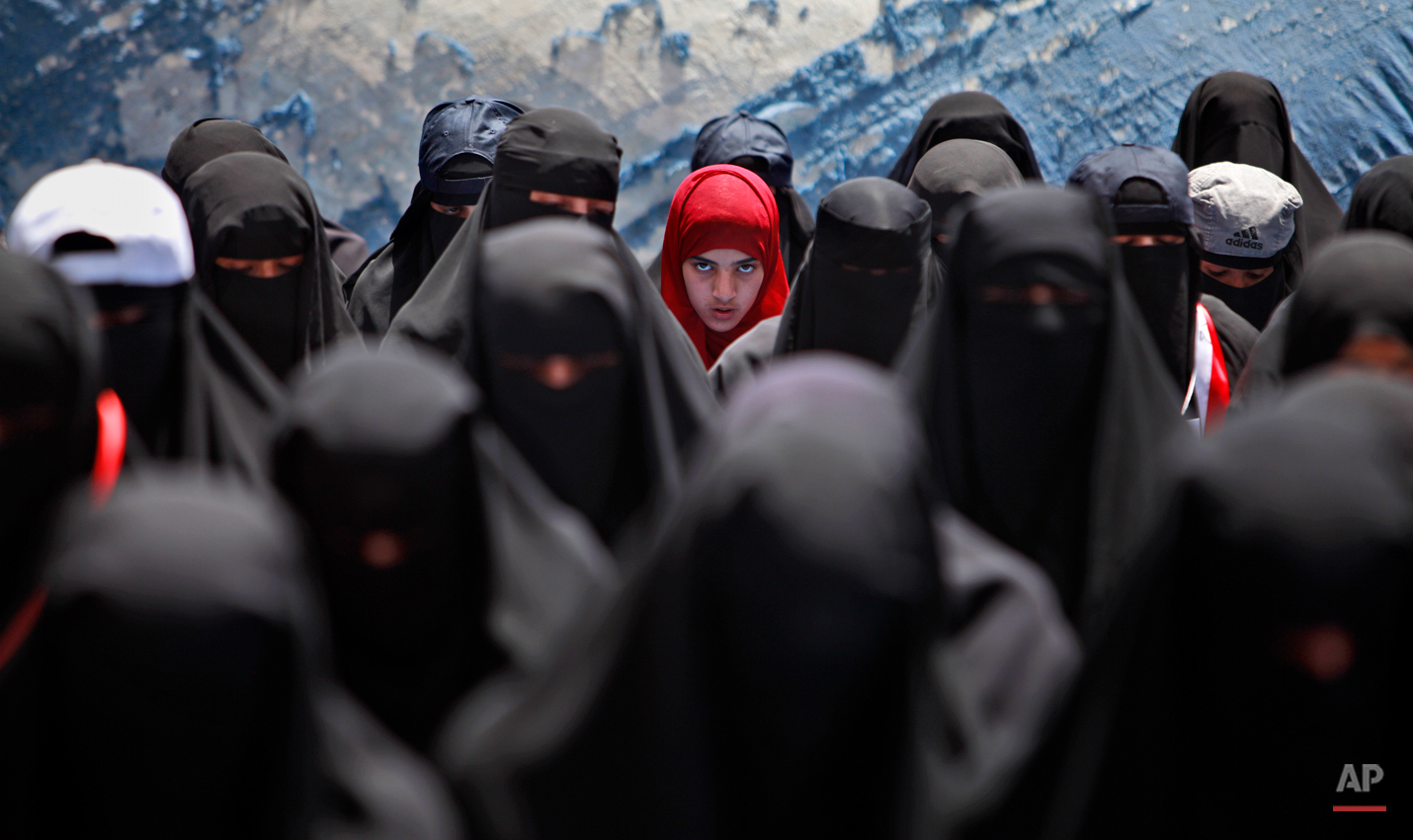  A female anti-government protestor, center, wearing a red scarf, looks on while praying with other women during a demonstration demanding the resignation of Yemeni President Ali Abdullah Saleh, in Sanaa,Yemen, Wednesday, April 6, 2011. Defying a dea