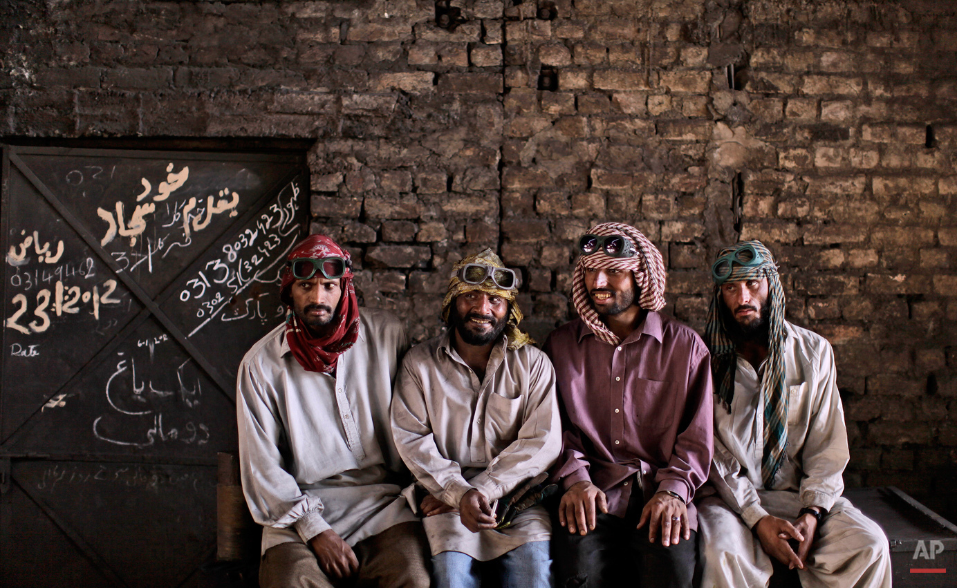  Pakistanis working at a steel mill, from right, Nazir Hameed, 42, Khalil Zada, 24, Azeem Ibrahim, 31, chat with another worker, not pictured, during a break, in Islamabad, Pakistan, Wednesday, May 23, 2012. (AP Photo/Muhammed Muheisen) 