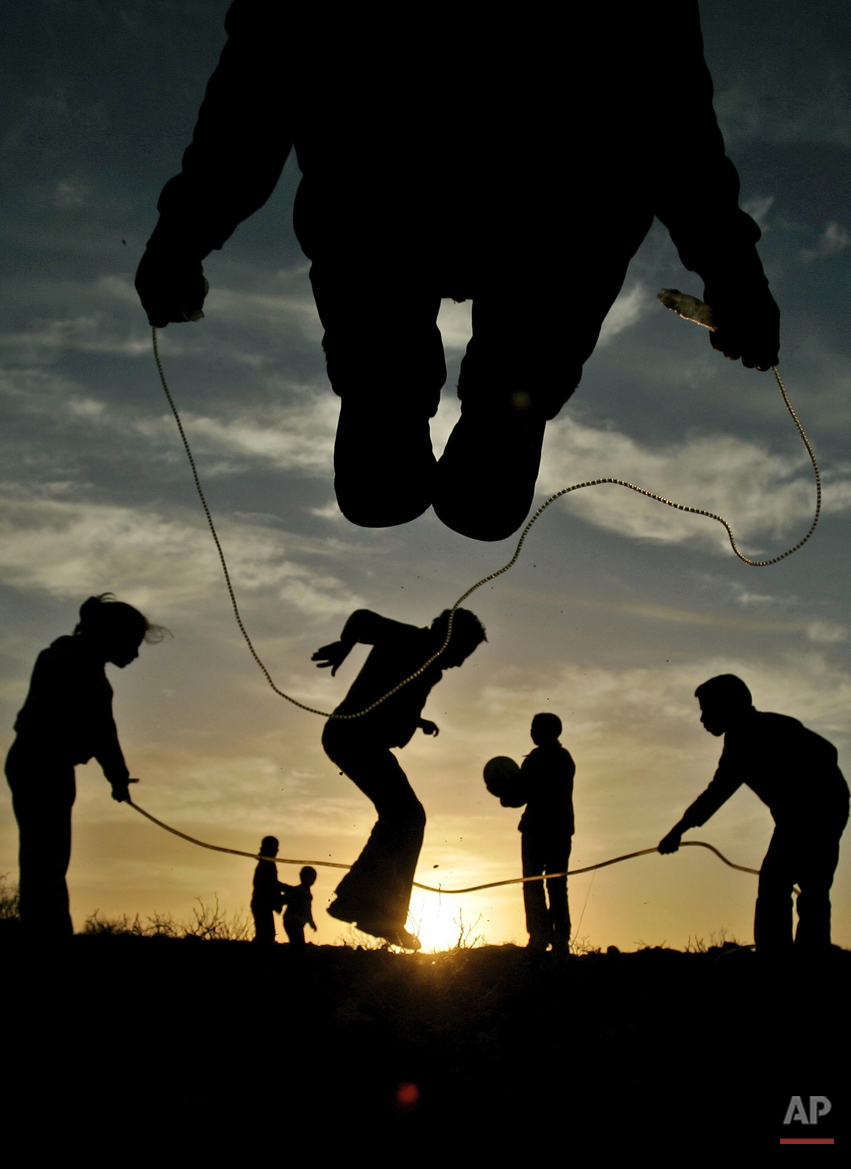  Palestinian youths and children play during sunset in the West Bank city of Ramallah, Saturday, Feb. 9, 2008. (AP Photo/Muhammed Muheisen) 